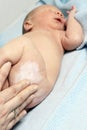 Mother moisturizing a newborn baby Royalty Free Stock Photo