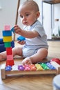 Mother With 8 Month Baby Son Learning Through Playing With Coloured Wooden Blocks At Home Royalty Free Stock Photo