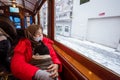 mother muslim sitting inside a tram with her son