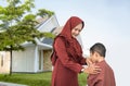 Mother muslim son shake and kiss hand