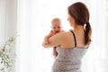 Mother with naked newborn on lighted white background