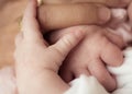 Mother and New born baby - holding hands