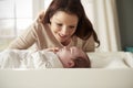 Mother With Newborn Baby Lying On Changing Table In Nursery Royalty Free Stock Photo