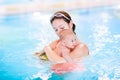 Mother and newborn baby son in swimming pool