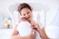 Mother and newborn baby in white nursery Royalty Free Stock Photo