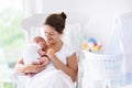 Mother and newborn baby in white nursery Royalty Free Stock Photo