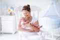 Mother and newborn baby in white nursery Royalty Free Stock Photo