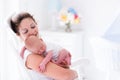 Mother and newborn baby in white nursery Royalty Free Stock Photo