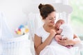 Mother and newborn baby in white nursery Royalty Free Stock Photo