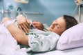 Child birth in maternity hospital. Mother and newborn. Young mom hugging her newborn baby after delivery. Woman giving birth Royalty Free Stock Photo