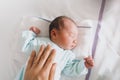 Mother and newborn resting after childbirth in maternity hospital room. Mother hugging her sleeping newborn baby Royalty Free Stock Photo