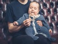 Mother offering baby teething ring