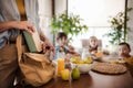 Mother packing school snacks for her children into school bag. Snack, school lunch in a snack box for school.