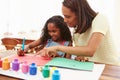 Mother Painting Picture With Daughter At Home