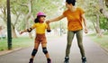 Mother, park and holding hands to rollerskate with girl child with care, learning and support. Interracial parent