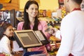 Mother Paying For Family Shopping At Checkout With Card Royalty Free Stock Photo