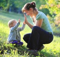 Mother play with her baby outdoor Royalty Free Stock Photo