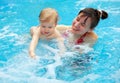 Mother play with her child in swimming-pool Royalty Free Stock Photo