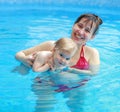 Mother play with her child in swimming-pool Royalty Free Stock Photo