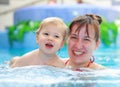 Mother play with her child in swimming-pool Royalty Free Stock Photo