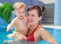 Mother play with her child in swimming-pool Royalty Free Stock Photo