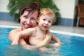 Mother play with her child in swimming-pool Royalty Free Stock Photo