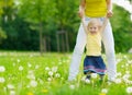 Mother playing with baby girl on dandelions field Royalty Free Stock Photo