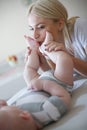 Mother playing on bed with her little baby boy. Close up Royalty Free Stock Photo