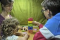 Mother playing a board game with her two children Royalty Free Stock Photo