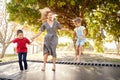 Mother Playing With Children On Outdoor Trampoline In Garden Royalty Free Stock Photo