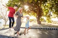 Mother Playing With Children On Outdoor Trampoline In Garden Royalty Free Stock Photo