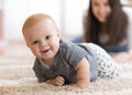 Mother playing with creeping on floor baby Royalty Free Stock Photo