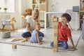 Mother playing with happy children on floor at home Royalty Free Stock Photo