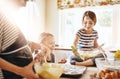 Mother, playing or happy kids baking in kitchen as a happy family with playful young siblings with flour. Dirty, messy Royalty Free Stock Photo