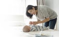 mother playing with her adorable little baby boy on bedroom Royalty Free Stock Photo