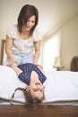 Mother playing with her baby in the bedroom Royalty Free Stock Photo