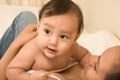 Mother playing with her baby boy son on bed Royalty Free Stock Photo