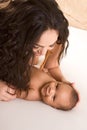 Mother playing with her baby boy son on bed Royalty Free Stock Photo