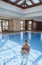 Mother playing with her baby at swimming pool indoor Royalty Free Stock Photo