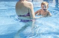 Mother playing with her baby at swimming pool indoor Royalty Free Stock Photo