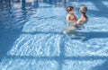 Mother playing with her baby at swimming pool indoor Royalty Free Stock Photo