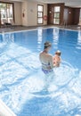 Mother playing with her baby at swimming pool indoor Royalty Free Stock Photo