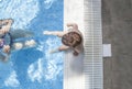 Mother playing with her baby at swimming pool indoor Royalty Free Stock Photo