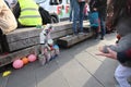 A Mother Playing with her child, the game is throw a balll to make the tin cans with the faces of several french politicians