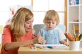 Mother playing with her child son, drawing together Royalty Free Stock Photo