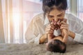 Mother playing her infant baby boy and kissing his feet with love Royalty Free Stock Photo