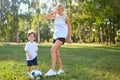 A mother is playing with her son in the ball in the park. Royalty Free Stock Photo