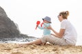 Mother playing his infant baby boy son on sandy beach enjoying summer vacationson on Lanzarote island, Spain. Family Royalty Free Stock Photo