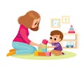 Mother playing with kid at home. Educational toys. Child playing designer cubes.
