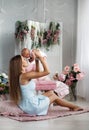 Mother playing with newborn baby sitting on the floor Royalty Free Stock Photo